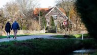 People walk on a street in the Dutch village Ommeren, Netherlands, January 6, 2023. (REUTERS/Piroschka van de Wouw)