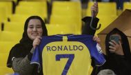 An Al Nassr fan poses holding a shirt with Cristiano Ronaldo's name on the back of it inside the stadium before the Saudi Pro League match between Al Nassr and Al Tai at the Mrsool Park, Riyadh, Saudi Arabia on January 6, 2023.  REUTERS/Ahmed Yosri