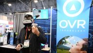 An attendee tries OVR Technology's ION 3 during the Consumer Electronics Show (CES) in Las Vegas, Nevada, on January 6, 2023. (Photo by Robyn Beck/ AFP)