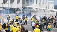 Supporters of Brazilian former President Jair Bolsonaro clash with the police during a demonstration outside the Planalto Palace in Brasilia on January 8, 2023. (Photo by EVARISTO SA / AFP)