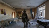 A Ukrainian serviceman is seen in a destroyed building of a school at a frontline, amid Russia's attack on Ukraine, in Donetsk region, Ukraine on January 7, 2023. REUTERS/Anna Kudriavtseva