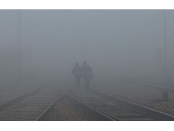 Men walk among heavy fog on a winter morning in New Delhi, India. Representational file photo. Reuters.