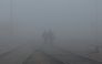 Men walk among heavy fog on a winter morning in New Delhi, India. Representational file photo. Reuters.