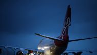 Technicians work on Virgin Orbit's LauncherOne rocket, attached to the wing of Cosmic Girl, a Boeing 747-400 aircraft, ahead of UK's First launch, at Spaceport Cornwall at Newquay Airport in Newquay, Britain, January 8, 2023. Reuters/Henry Nicholls