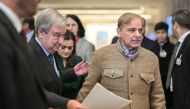 UN Secretary-General Antonio Guterres (left) arrives with Pakistan's Prime Minister Shehbaz Sharif to a statement on Pakistan's Resilience to Climate Change conference in Geneva on January 9, 2023. (Photo by Fabrice COFFRINI / AFP)