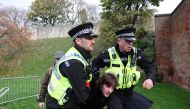 File Photo: Police officers restrain a man who threw an egg at King Charles during his visit to Micklegate bar in York, Britain, November 9, 2022. (REUTERS/Russell Cheyne)

