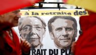 A banner depicting French Prime Minister Elisabeth Borne and French President Emmanuel Macron is pictured as protestors attend a demonstration against pension reform in Rennes on the day the French government unveils its pension reform, France, on January 10, 2023. REUTERS/Stephane Mahe