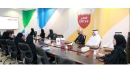 Officials and Community College of Qatar students during a session at QOC. 
