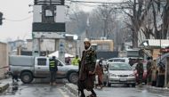 A member of Taliban security force stands guard on a blocked road after a suicide blast near Afghanistan's foreign ministry at the Zanbaq Square in Kabul on January 11, 2023. (Photo by Wakil Kohsar / AFP)