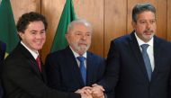 Brazil's President Luiz Inacio Lula da Silva (centre), Senate President Veneziano Vital do Rego (left) and Lower House's President Arthur Lira pose for a picture during a meeting with parliamentarians who submitted the document approving the decree of federal intervention, in the Public Security Secretariat at Planalto Palace, Brasilia, on January 11, 2023. (Photo by EVARISTO SA / AFP)