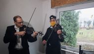 Musicians Thomas Gerlinger, 54, and Luppe, over 50, play violin and viola in an abandoned house in protest against demolishing Luetzerath village to expand the Garzweiler open-cast lignite mine of Germany's utility RWE, in Luetzerath, Germany, on January 12, 2023.