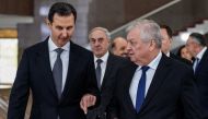 A handout picture released by the official Syrian Arab News Agency shows Syria's President Bashar al-Assad (left) receiving Russia's Special Envoy for Syria Alexander Lavrentiev and his accompanying delegation in the capital Damascus on January 12, 2023. (Photo by SANA / AFP)