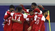Oman’s players celebrate after scoring their first goal against Saudi Arabia, yesterday. REUTERS 