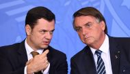 File photograph taken on June 27, 2022, then Brazilian President Jair Bolsonaro (L) and his Minister of Justice Anderson Torres during an event. (Photo by Evaristo SA / AFP)