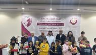 QCF Secretary General Yousef Mohammed Al Mutawa poses for a group photo with the participants. 