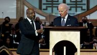 US President Joe Biden stands next to Senator Raphael Warnock (D-GA), a senior pastor at Ebenezer Baptist Church, ahead of the holiday honoring Martin Luther King Jr., in Atlanta, Georgia, US, on January 15, 2023. REUTERS/Joshua Roberts