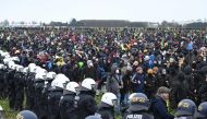 Police face protesters during a large-scale protest to stop the demolition of the village Luetzerath to make way for an open-air coal mine extension on January 14, 2023.  (Photo by INA FASSBENDER / AFP)