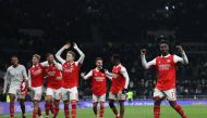 Arsenal's English midfielder Bukayo Saka (R) celebrates with teammates on the pitch after the English Premier League match between Tottenham Hotspur and Arsenal at Tottenham Hotspur Stadium in London, on January 15, 2023.  (Photo by ADRIAN DENNIS / AFP)