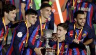 FC Barcelona's Marcos Alonso, Pedri, Ferran Torres, Gavi and Eric Garcia celebrate with the trophy after winning the Spanish Super Cup Reuters/Ahmed Yosri
