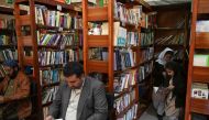 In this photograph taken on December 14, 2022, people read books inside the Darra Adam Khel Library in Darra Adamkhel town, some 35 kilometres (20 miles) south of Peshawar. (Photo by Abdul Majeed / AFP)