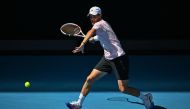 Austria's Dominic Thiem hits a return against Russia's Andrey Rublev during their men's singles match on day two of the Australian Open tennis tournament in Melbourne on January 17, 2023. (Photo by ANTHONY WALLACE / AFP)