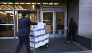 Legal aides move boxes of material as they arrive for the Elon Musk shareholder lawsuit trial at the Phillip Burton Federal Building on January 17, 2023 in San Francisco, California. Justin Sullivan/Getty Images/AFP