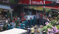 Rescue workers carry out equipment from a Circle-K convenience store after part of the building collapsed, killing a 15-year-old girl, in Ho Chi Minh City on January 18, 2023. Photo by Dat Tran / AFP