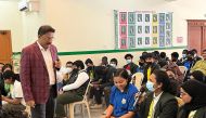 Dr. Rajeev Thomas interacting with students during a session at Olive International School.