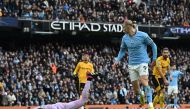 Manchester City's Erling Haaland (right) celebrates past Wolverhampton Wanderers' goalkeeper Jose Sa after scoring his team third goal during the English Premier League match between Manchester City and Wolverhampton Wanderers at the Etihad Stadium in Manchester, north west England, on January 22, 2023. (Photo by Paul ELLIS / AFP)