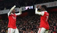 Arsenal's English striker Eddie Nketiah (left) celebrates with Arsenal's English midfielder Bukayo Saka after scoring their third goal during the English Premier League match between Arsenal and Manchester United at the Emirates Stadium in London on January 22, 2023. (Photo by Glyn KIRK / AFP)