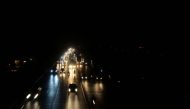 Commuters make their way along a street during a nationwide power outage, in Islamabad on January 23, 2023. - (Photo by Farooq Naeem / AFP)