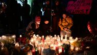 People pay tribute to the victims of the mass shooting at a candlelight vigil in front of City Hall in Monterey Park, California, on January 24, 2023. Photo by Frederic J. Brown / AFP