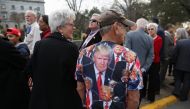 A man wears a T-shirt with images of former US President Donald Trump on it, on the day of Donald Trump's campaign stop to unveil his leadership team, at the South Carolina State House in Columbia, South Carolina, US, January 28, 2023. REUTERS/Shannon Stapleton