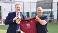 Officials with a rugby jersey.