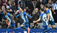 Brighton's Japanese midfielder Kaoru Mitoma (centre) celebrates with teammates after scoring their second goal during the English FA Cup fourth round football match between Brighton & Hove Albion and Liverpool at the Amex stadium in Brighton, on the south coast of England on January 29, 2023.  (Photo by Glyn KIRK / AFP)