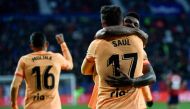Atletico Madrid's midfielder Saul Niguez celebrates with teammates after scoring his team's first goal during the Spanish league match between CA Osasuna and Club Atletico de Madrid at El Sadar stadium in Pamplona on January 29, 2023. (Photo by ANDER GILLENEA / AFP)