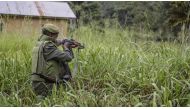A soldier of the FARDC (Armed Forces of the Democratic Republic of the Congo) takes cover during exchanges of fire with members of the ADF (Allied Democratic Forces) in Opira, North Kivu, on January 25, 2018. File Photo / AFP
