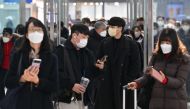 People wearing face masks make their way at Seoul railway station in Seoul on January 30, 2023, after South Korea lifted its indoor mask mandate as Covid cases dwindle. Photo by Jung Yeon-je / AFP