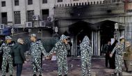 Egyptian security forces stand guard outside al-Noor al-Mohammadi charitable hospital after a fire broke out, in Cairo on February 1, 2023. (Photo by Sayed HASAN / AFP)