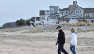 In this file photo taken on November 07, 2021, US President Joe Biden and First Lady Jill Biden walk on Rehoboth Beach, Delaware.  (Photo by Nicholas Kamm / AFP)