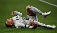 Paris Saint-Germain's French forward Kylian Mbappe lies on the ground after getting injured during the French L1 football match between Montpellier Herault SC and Paris Saint-Germain at Stade de la Mosson in Montpellier, southern France on February 1, 2023. (Photo by Sylvain Thomas / AFP)