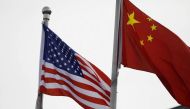 Chinese and US flags flutter outside the building of an American company in Beijing, China January 21, 2021. (REUTERS/Tingshu Wang)