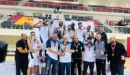 Al Sadd's players and officials celebrate with the trophy.