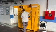 FILE PHOTO: A worker installs a new Amazon locker inside a public parking in Ronda, Spain, June 7, 2022. REUTERS/Jon Nazca