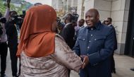Tanzanian President Samia Suluhu Hassan (left) is greeted by Burundi's President Evariste Ndayishimiye as he arrives for the extraordinary Summit of East African Community Heads of State at the state house in Bujumbura, Burundi, on February 4, 2023.  (Photo by Tchandrou Nitanga / AFP)