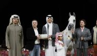 H E Sheikh Thani bin Hamad Al Thani with a winner of Arabian Peninsula Horse show.