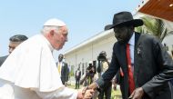 This handout photo taken and released on February 5, 2023 by the Vatican Media shows the President of South Sudan Salva Kiir greeting Pope Francis before the Pope departs South Sudan, at the Juba International Airport in Juba.  (Photo by VATICAN MEDIA / AFP)