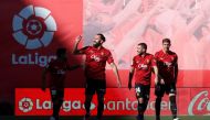 Mallorca's Kosovar forward Vedat Muriqi (second left) celebrates after an unintentional goal by Real Madrid's Spanish defender Nacho Fernandez during the Spanish League match between RCD Mallorca and Real Madrid at the Visit Mallorca stadium in Palma de Mallorca on February 5, 2023. (Photo by JAIME REINA / AFP) 