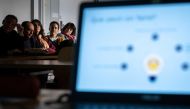 Teachers are seen behind a laptop during a workshop on ChatGpt bot organised for by the School Media Service (SEM) of the Public education of the Swiss canton of Geneva, on February 1, 2023. (Photo by Fabrice COFFRINI / AFP)