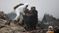 Rescue teams carry a casualty pulled out of the rubble following an earthquake in the town of Jan-daris, in the countryside of Syria's northwestern city of Afrin in the rebel-held part of Aleppo province, on February 6, 2023. (Photo by Bakr ALKASEM / AFP)